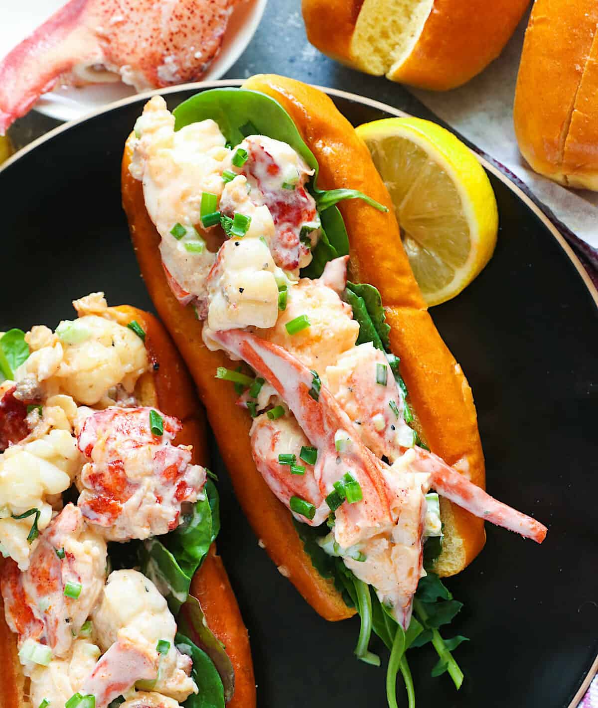 Enjoying soul-satisfying lobster rolls with a lemon slice