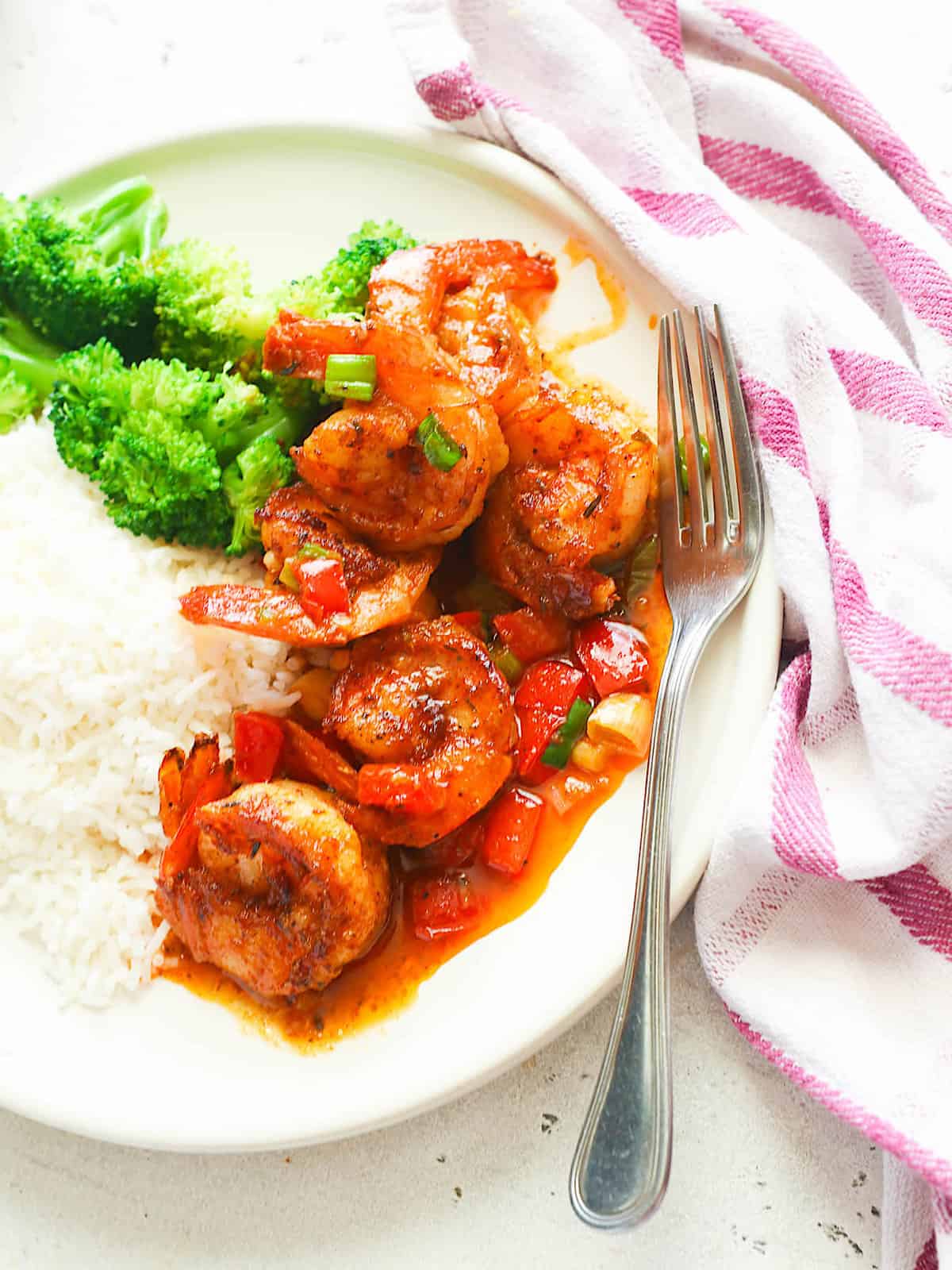 Cajun shrimp served with rice and blanched broccoli