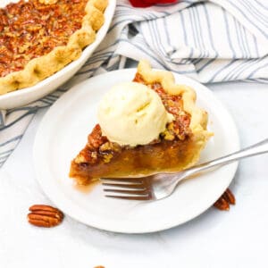 Serving up a slice of sweet potato pecan pie with ice cream for the ultimate comfort dessert