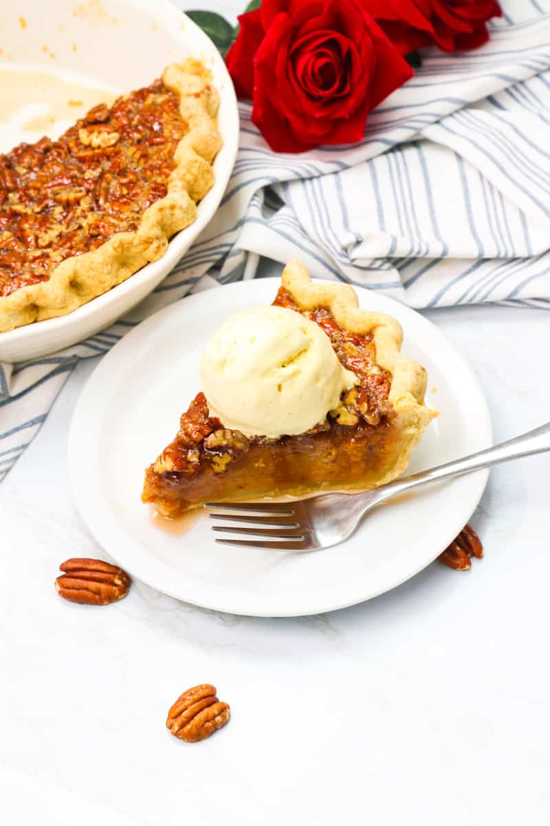 Serving up a slice of sweet potato pecan pie with ice cream for the ultimate comfort dessert