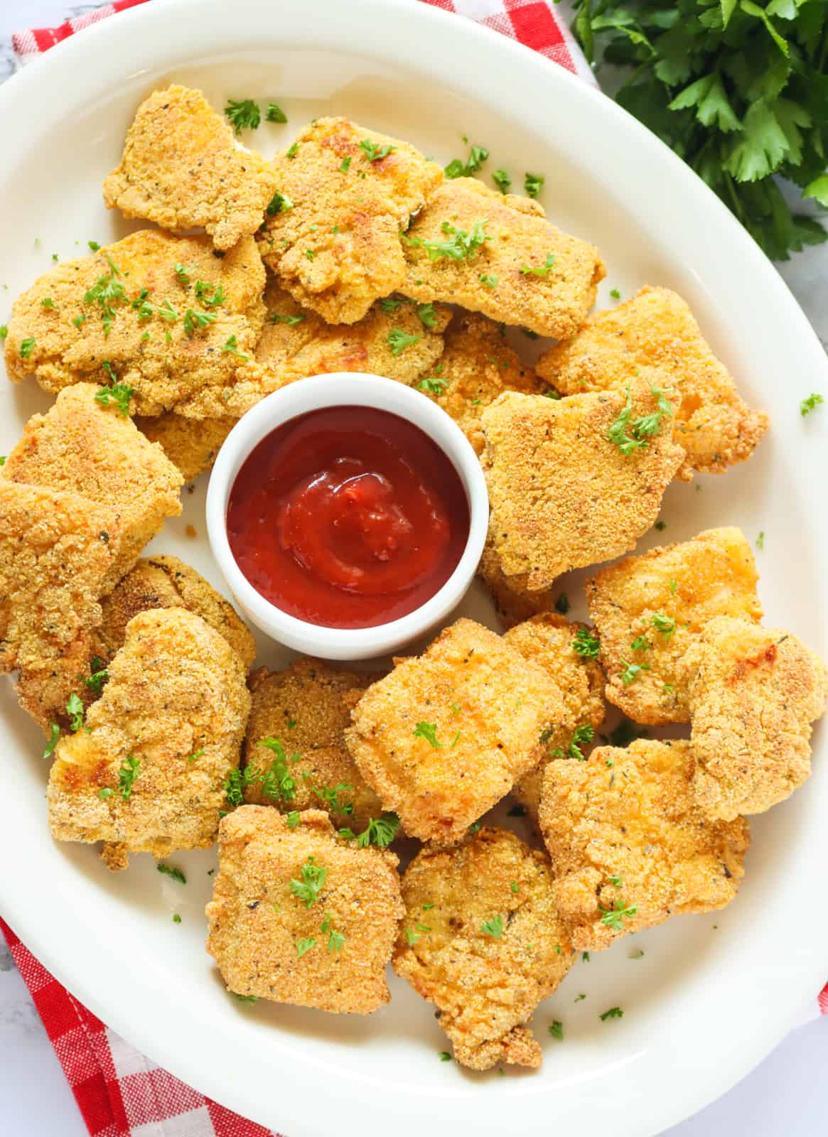 Enjoy super delicious catfish fried nuggets with ketchup on a platter
