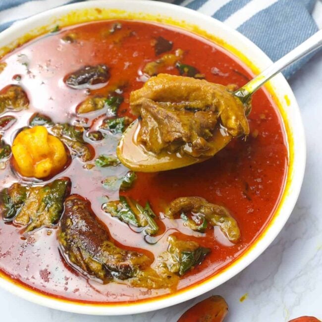 Spooning up a bowl of amazing palm nut soup