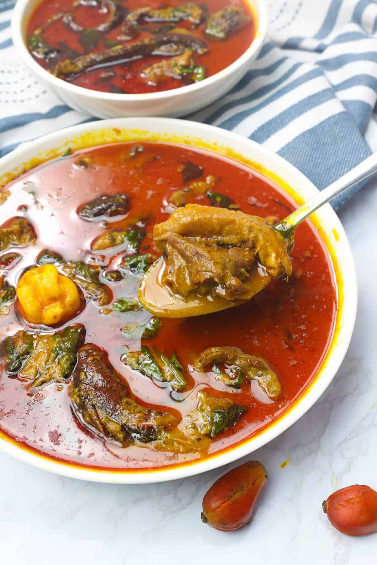 Spooning up a bowl of amazing palm nut soup