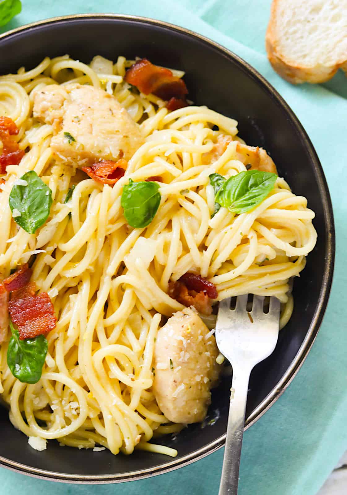 Wrapping delicious spaghetti on your fork for a decadent chicken carbonara experience