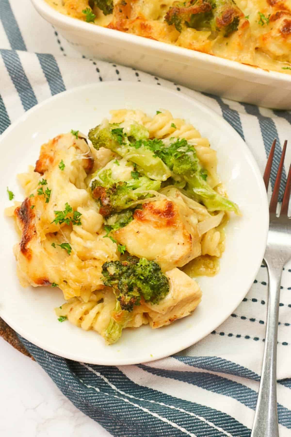 A soul-satisfying serving of chicken pasta bake on a white plate