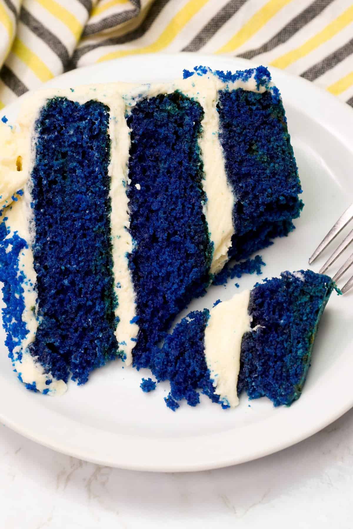 Enjoying a bite of surreal blue velvet cake