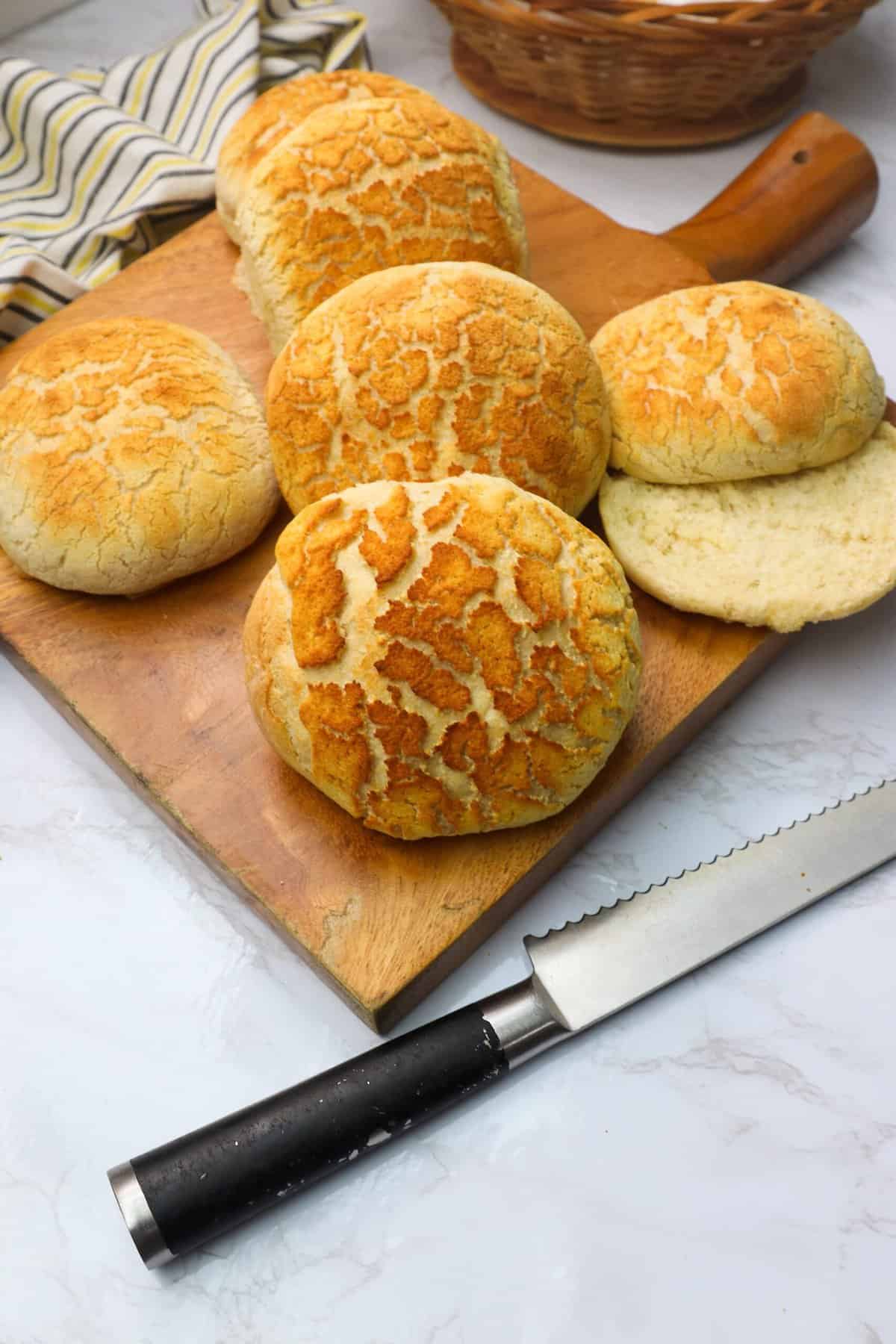 Slicing open a hot Dutch crunch bread roll for a delectable sandwich