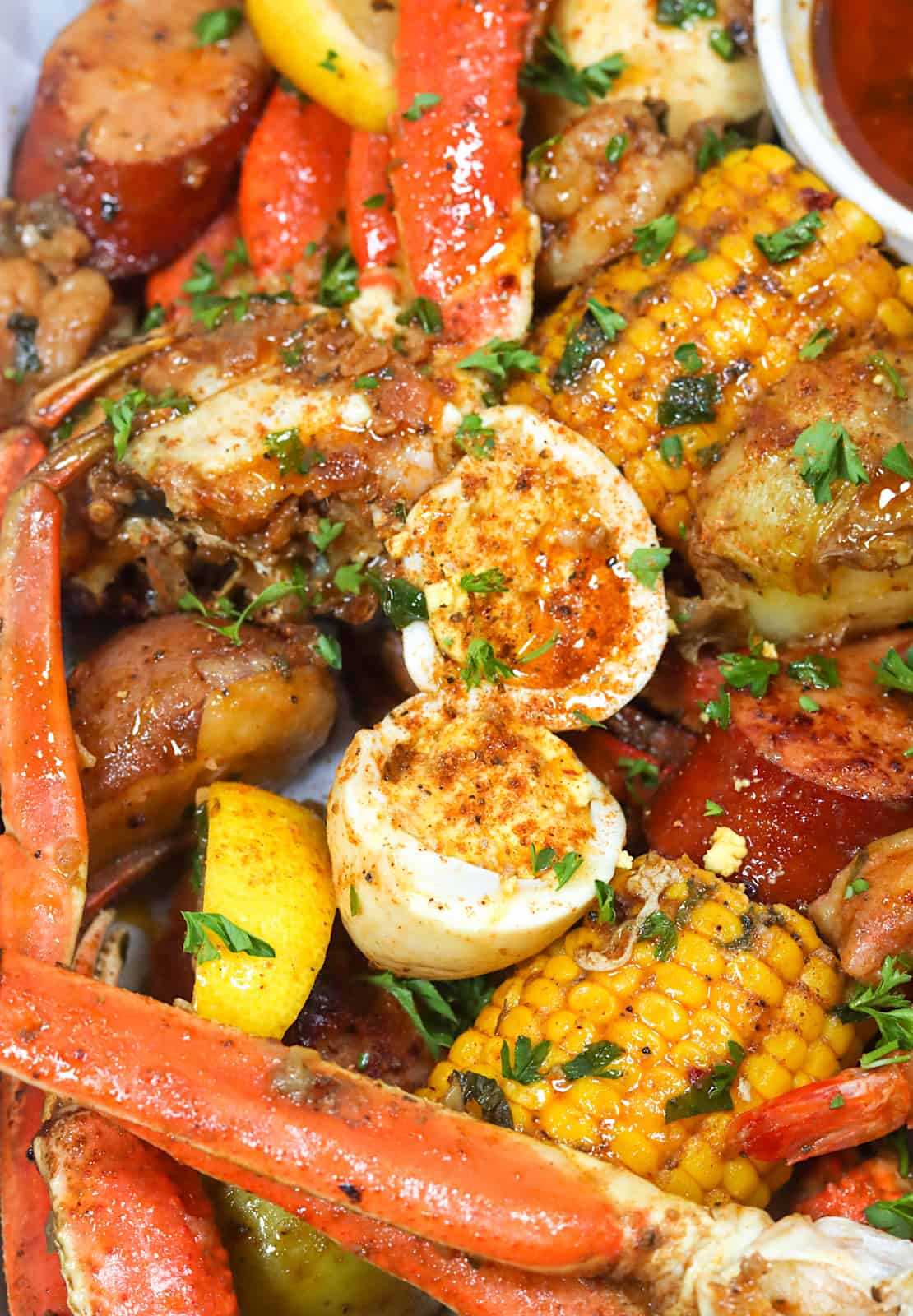 A closeup of tasty cooked eggs in the seafood boil in a bag