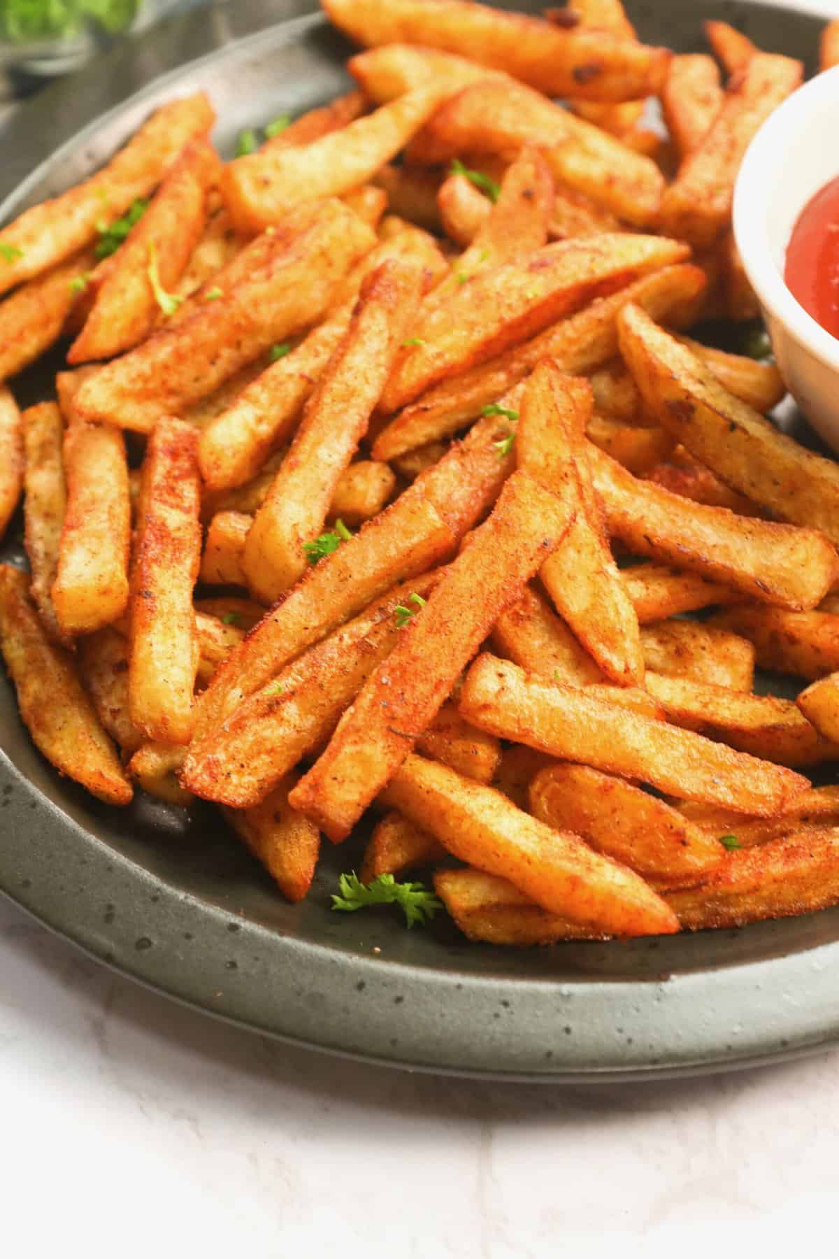 Serving up Cajun fries on a plate for pure comfort food