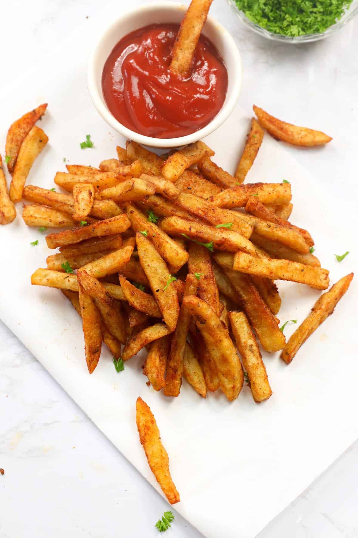 Baked Cajun fries fresh from the oven with ketchup