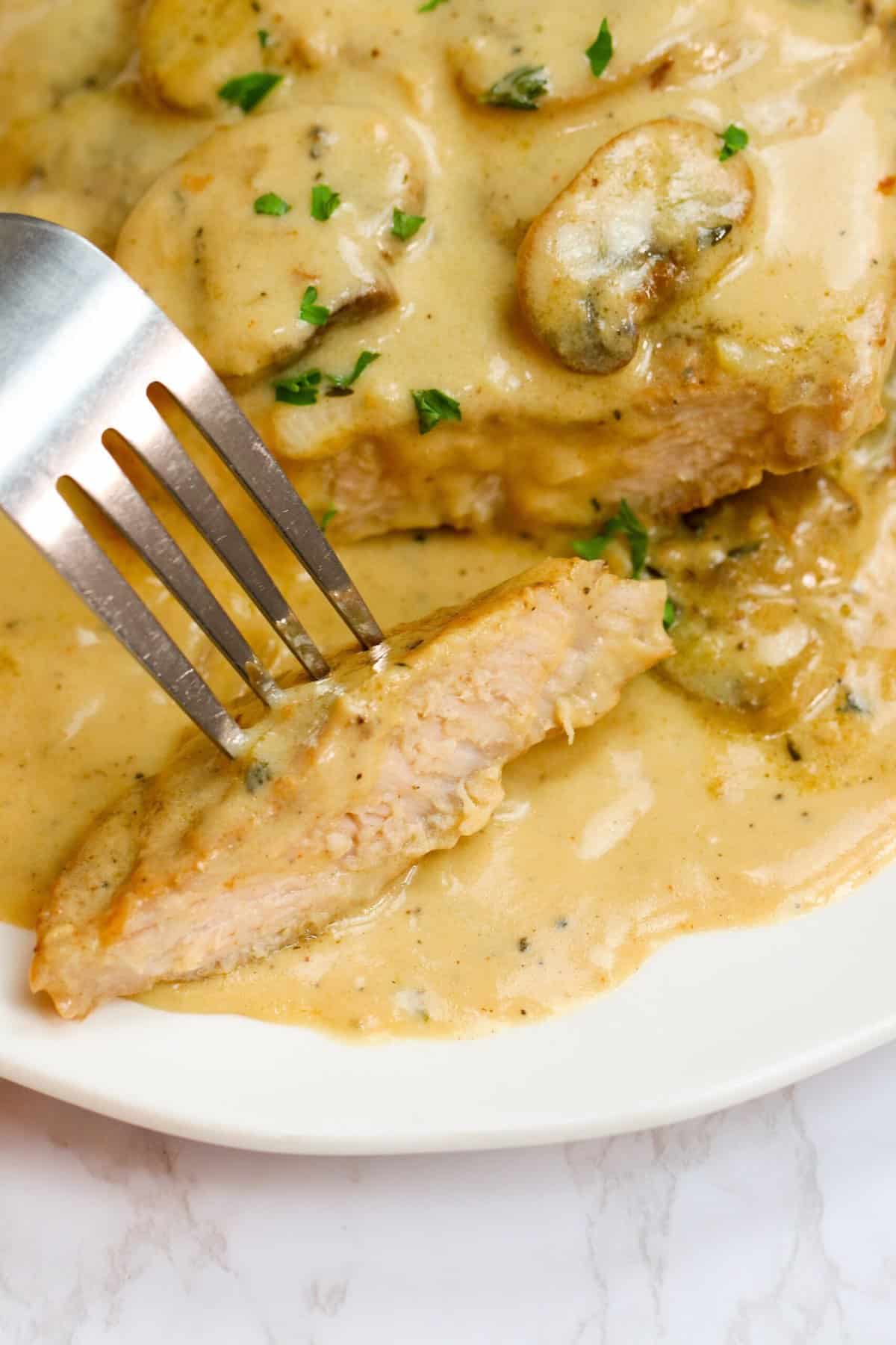Biting into a tender pork chop smothered in cream of mushroom sauce