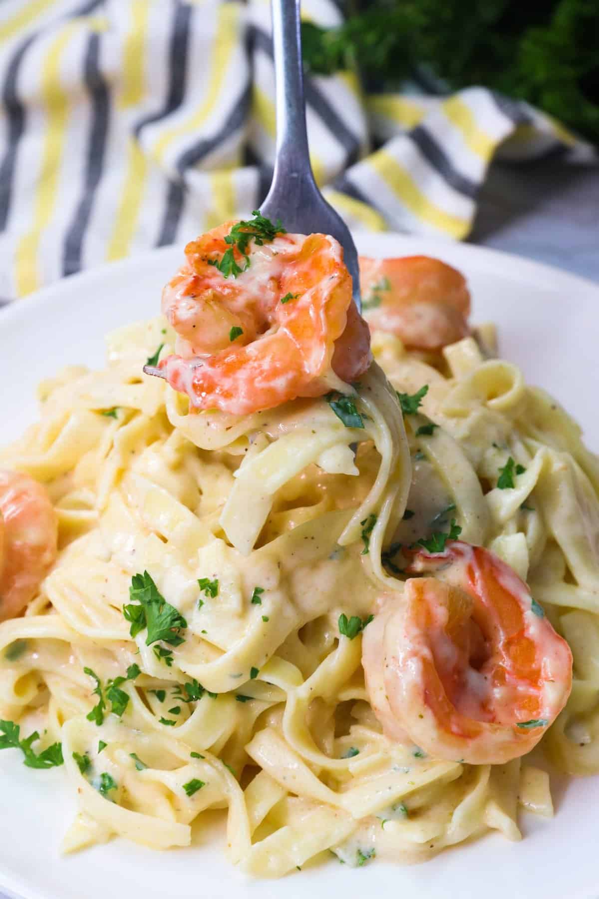 Diving into a decadent plate of shrimp Alfredo pasta