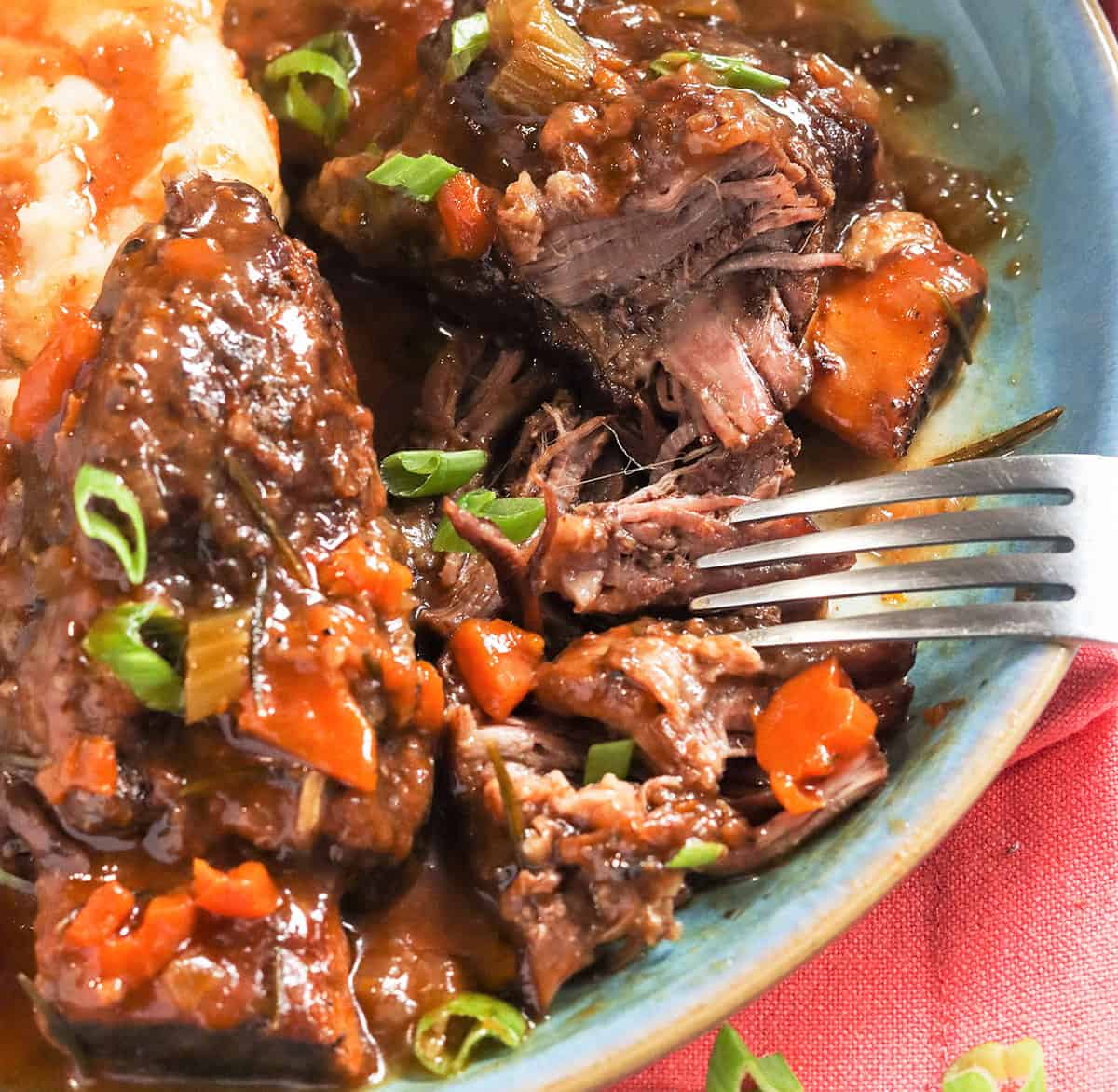 Digging into Instant Pot short ribs and showing off that tender, fall-off-the-bone deliciousness