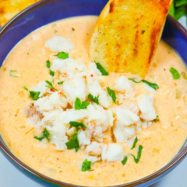 Dipping crusty bread into a steaming hot bowl of she crab soup