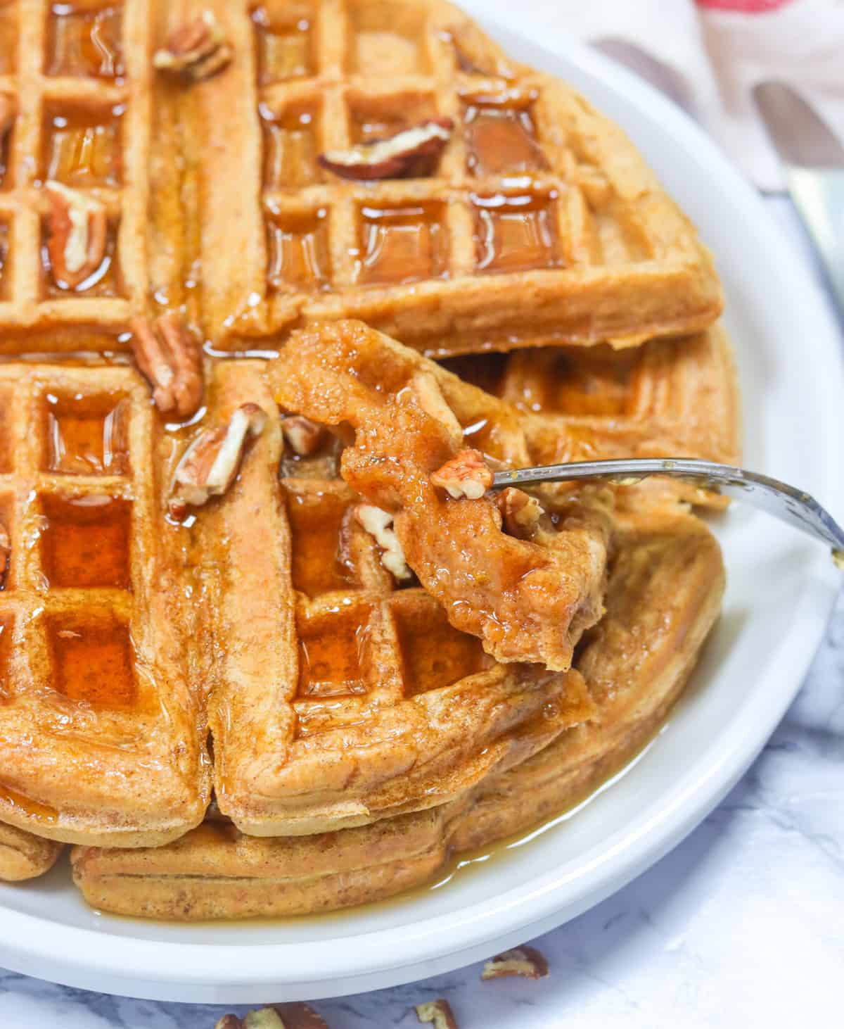 Taking a ridiculously delicious bite of maple syrup smothered sweet potato waffles