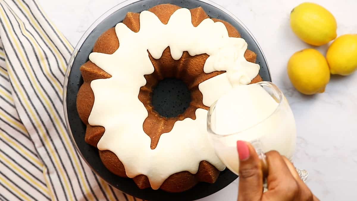 Drizzling the glaze on the lemon bundt cake