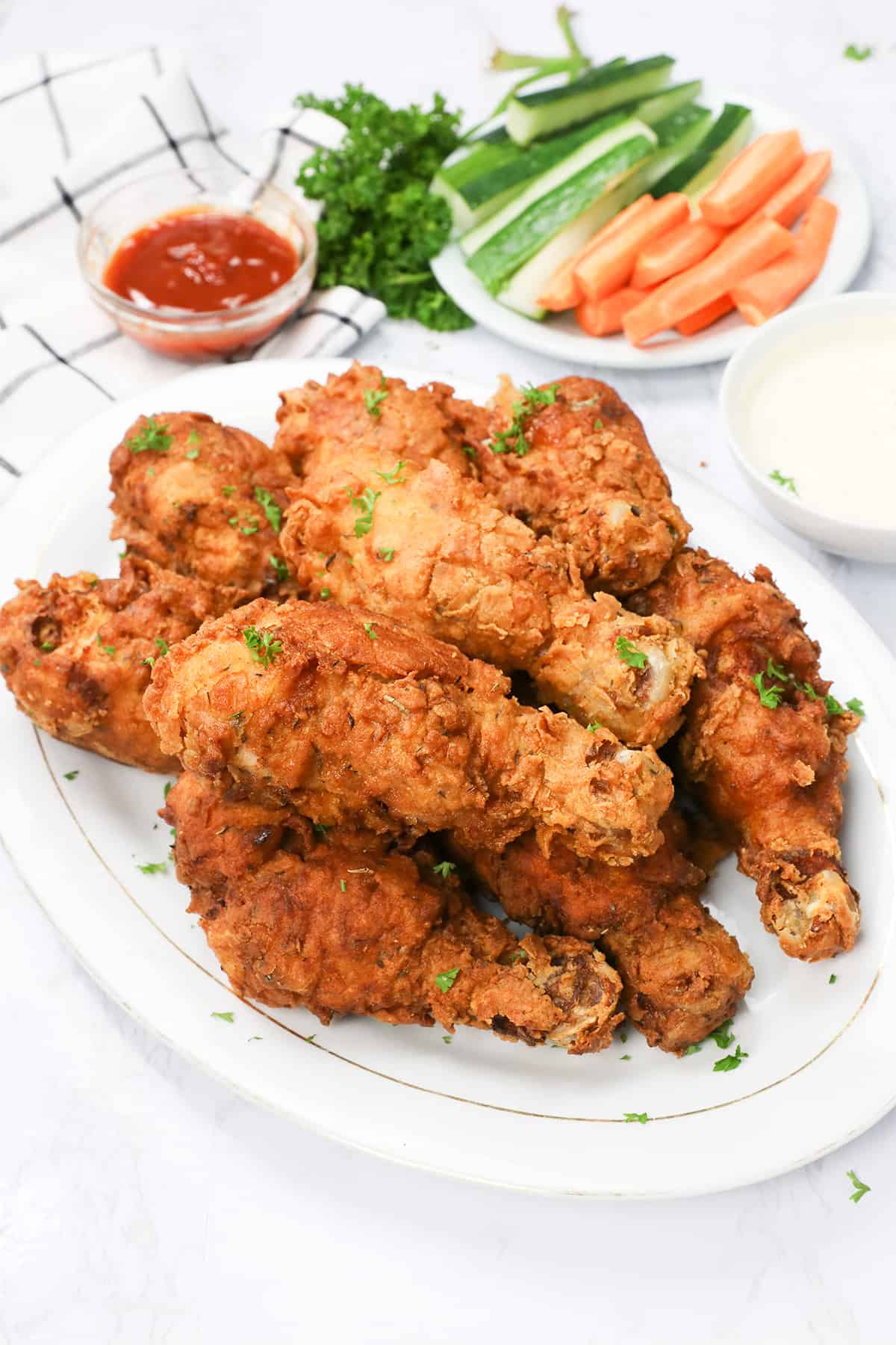 All-time favorite deep fried Chicken Legs with carrot and celery sticks