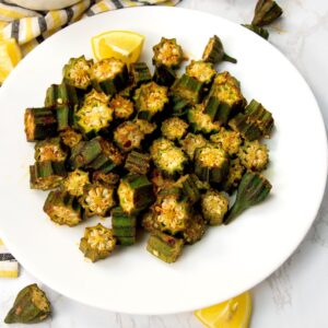 Enjoying a plateful of oven roasted okra with sauce in the background