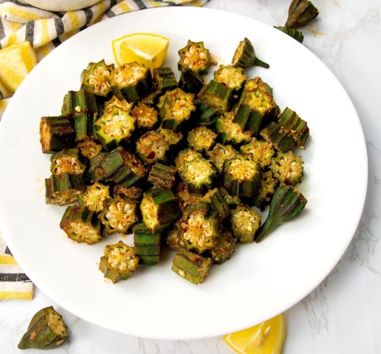 Enjoying a plateful of oven roasted okra with sauce in the background