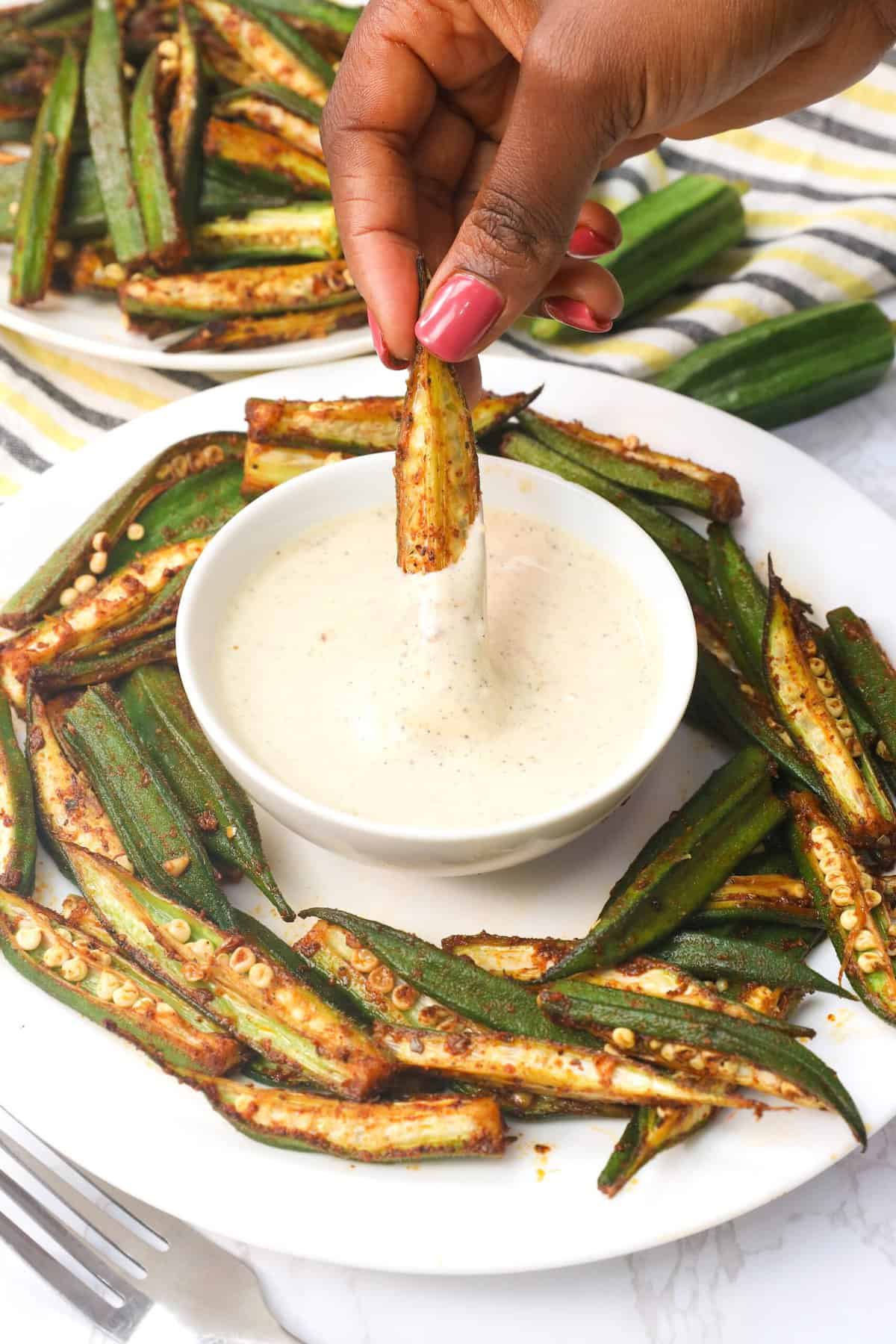 Dipping whole oven roasted okra in mayo sauce