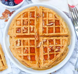 Serving up fresh, homemade sweet potato waffles with fresh berries and maple syrup