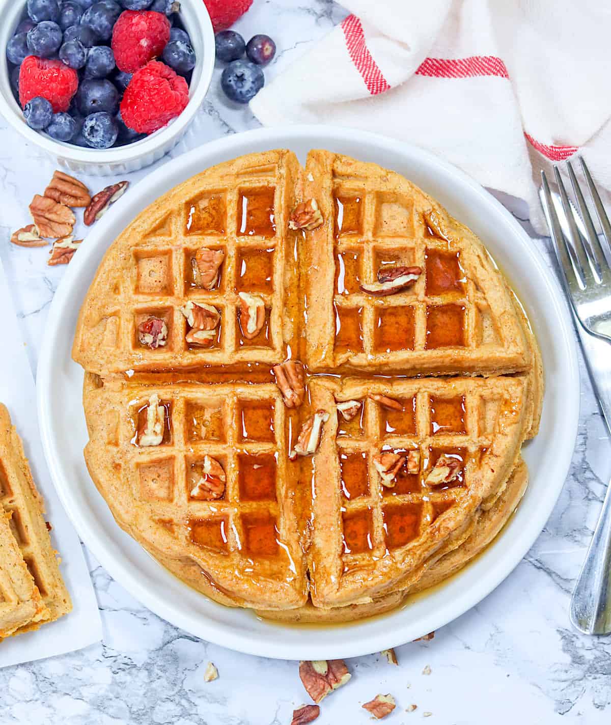 Serving up fresh, homemade sweet potato waffles with fresh berries and maple syrup