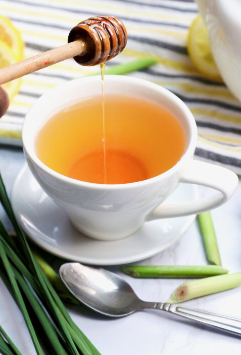 Drizzling honey in a deliciously hot cup of homemade lemongrass tea