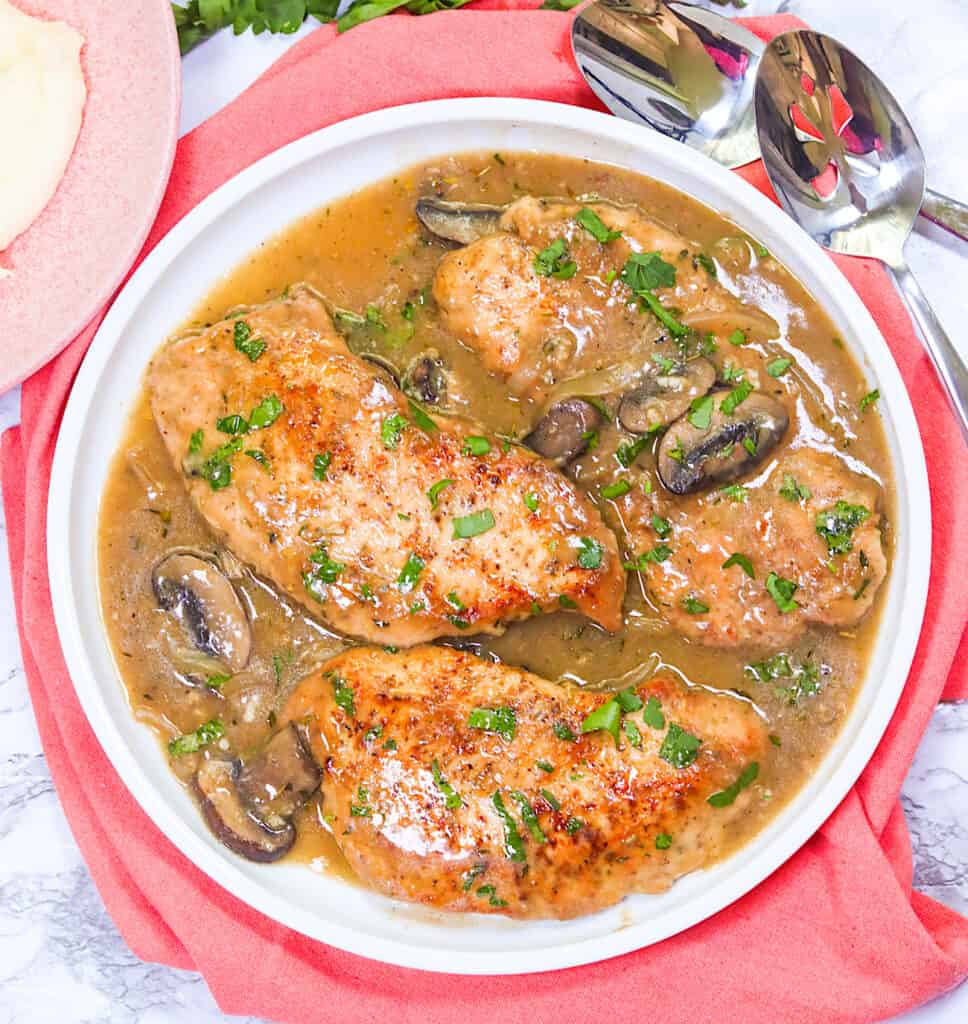 A serving plate full of crazy tender smothered turkey chops