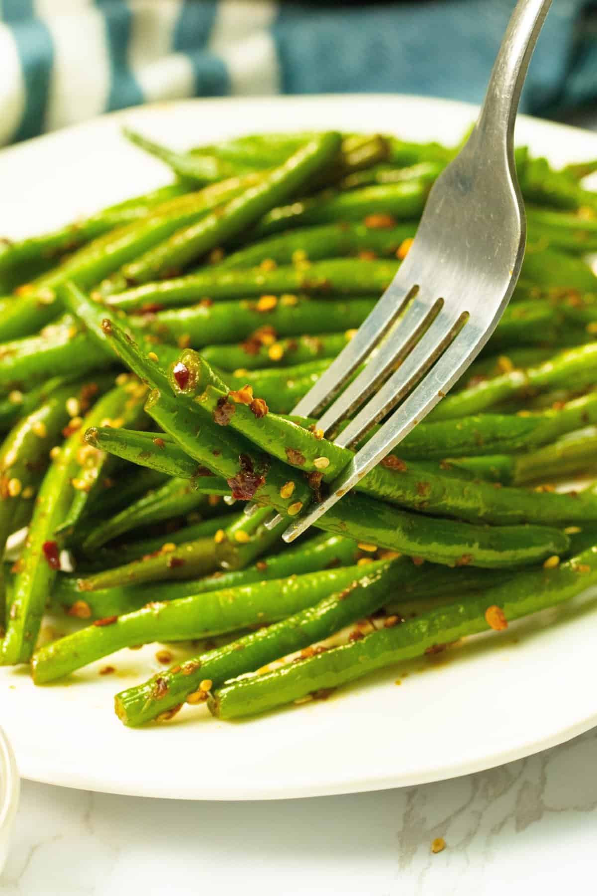 Enjoying a forkful of spicy green beans