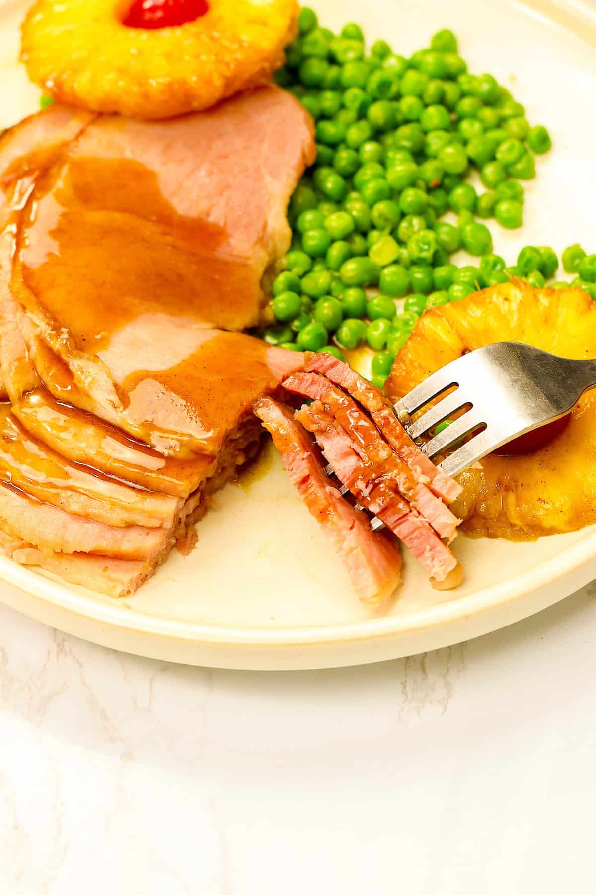 Pineapple Honey Baked Ham with tender baby peas