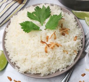 Tropically delicious Jasmine Coconut Rice garnished with cilantro and toasted coconut