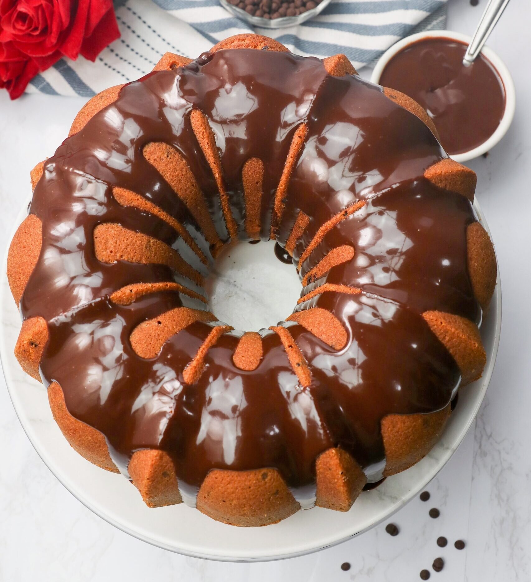 A freshly glazed bundt cake loaded with chocolate chips ready to serve and enjoy.