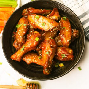 Mind-blowing honey hot wings with celery and carrot sticks and a delectable dipping sauce