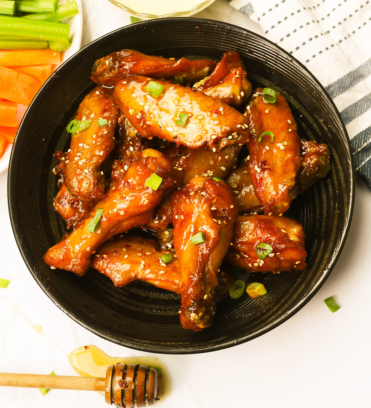 Mind-blowing honey hot wings with celery and carrot sticks and a delectable dipping sauce