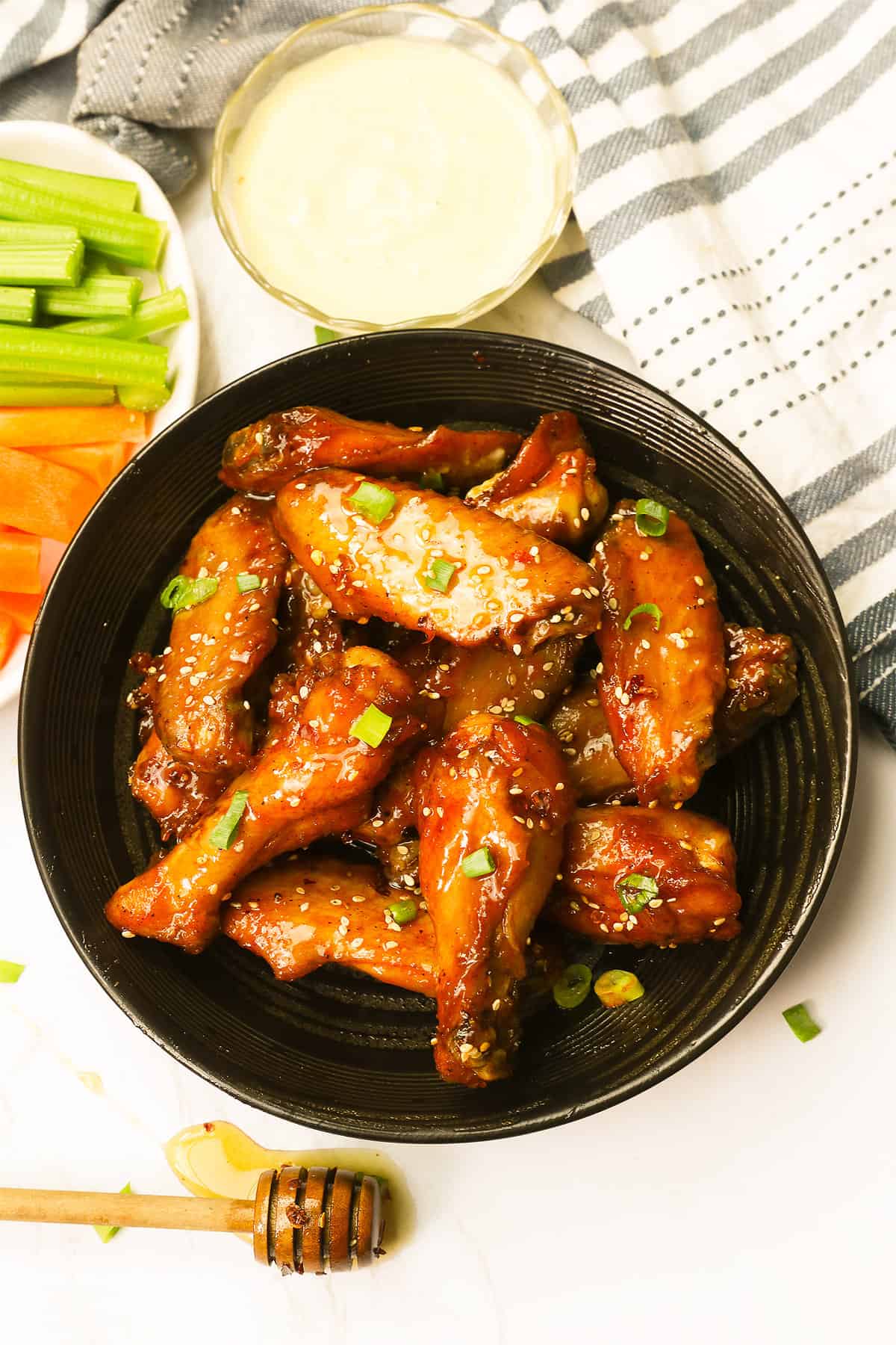 Mind-blowing honey hot wings with celery and carrot sticks and a delectable dipping sauce