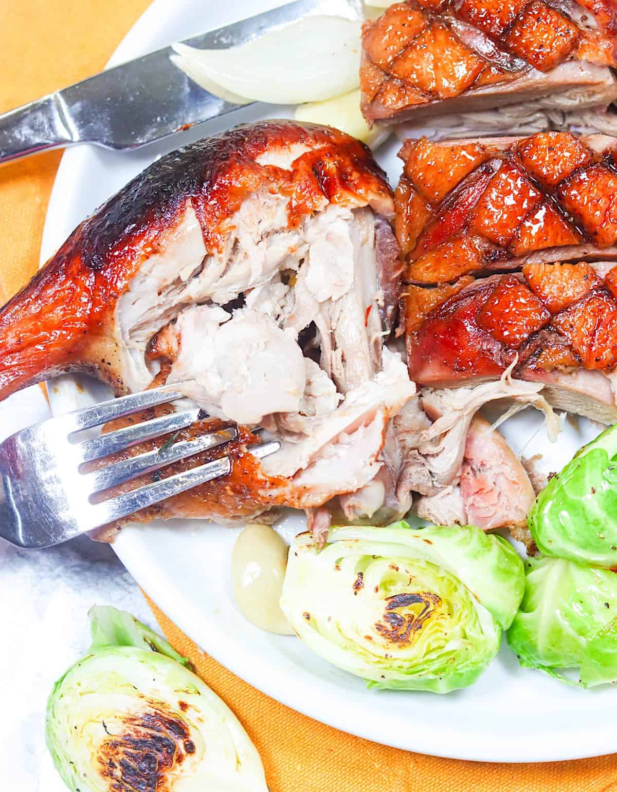 Enjoying the decadent texture of Whole Roast Duck with roasted Brussels sprouts