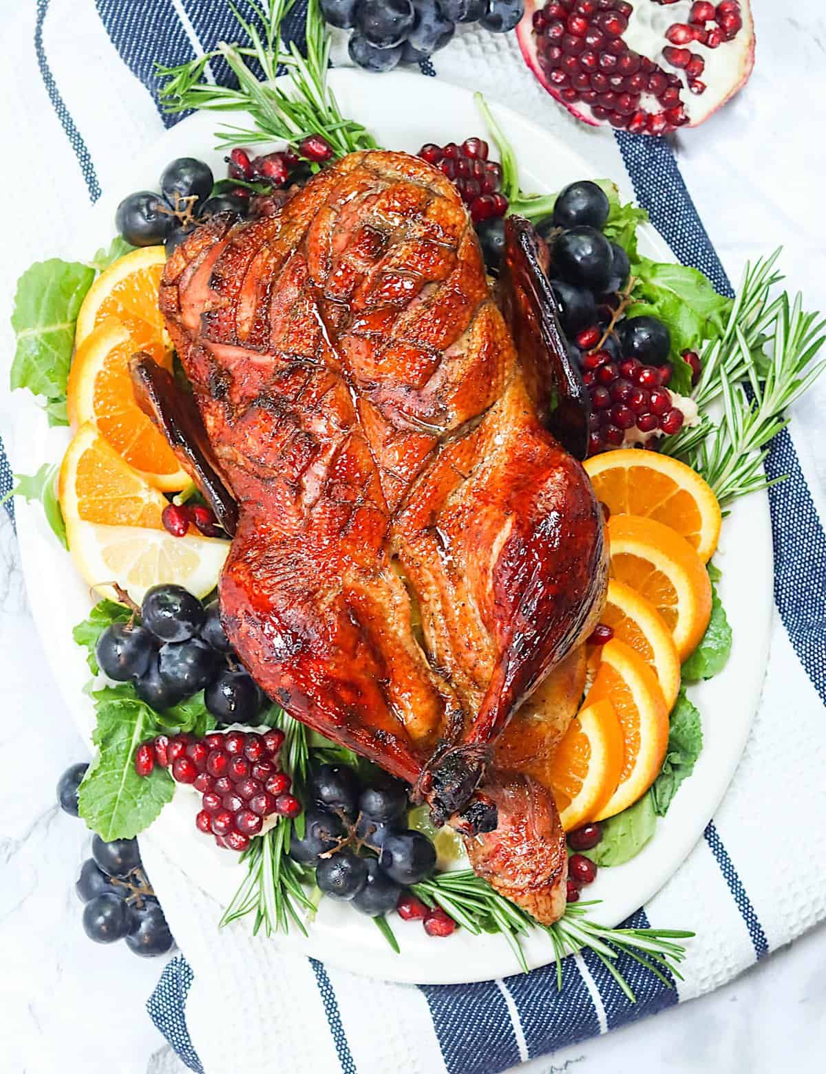 Whole Roast Duck on a gorgeous platter with grapes and orange slices