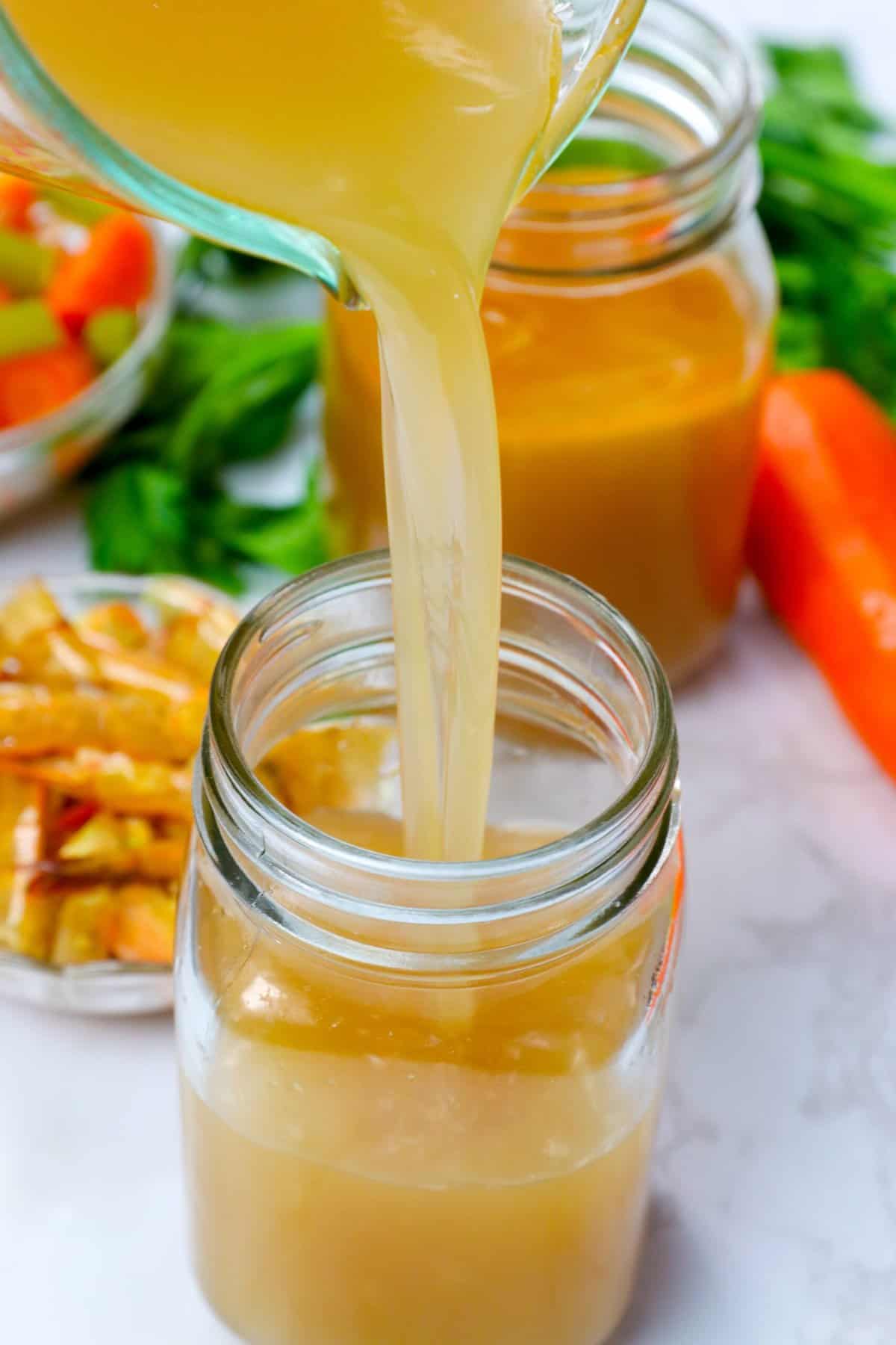 Pouring freshly made Shrimp Stock into a storage jar to make delicious jambalaya later