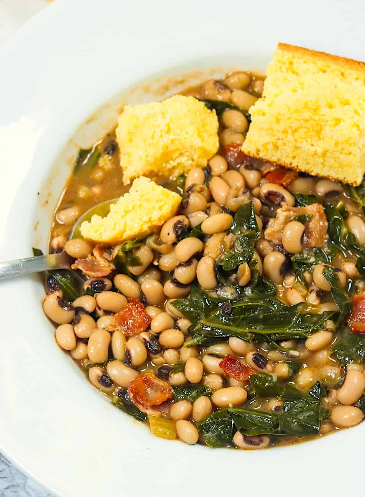 Diving into an insanely delicious bowl of Black-Eyed Peas and Collard Greens 