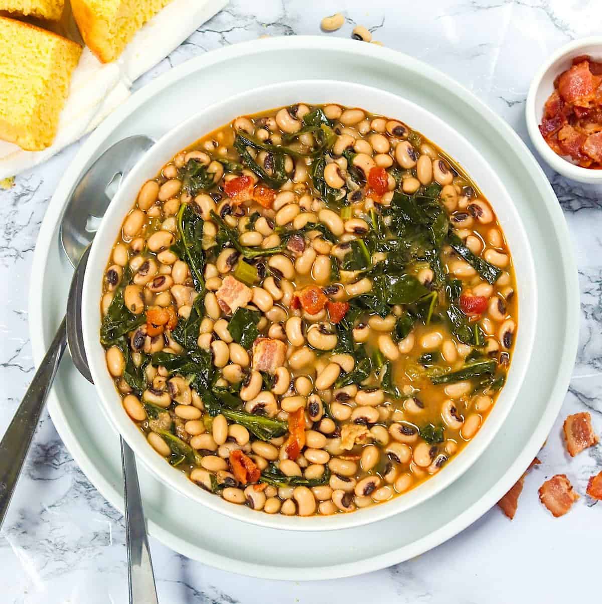 Enjoying soul food Black-Eyed Peas and Collard Greens with cornbread