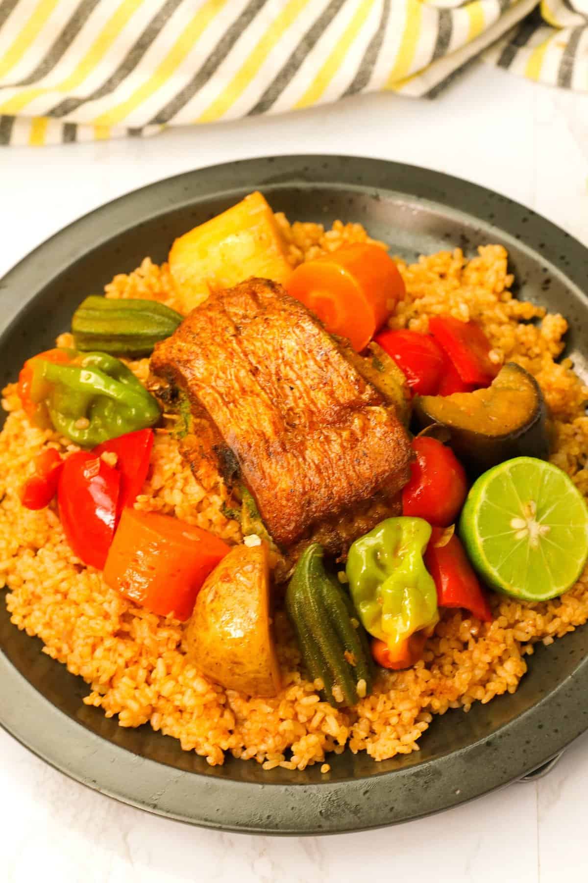 Enjoying a plateful of tasty Thieboudienne with vegetables and rice