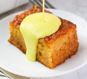 Drizzling decadent soul-satisfying malva pudding cake with cream sauce