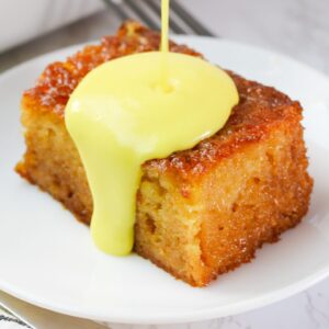 Drizzling decadent soul-satisfying malva pudding cake with cream sauce