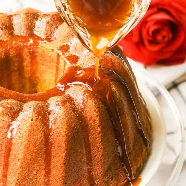 Glazing a rum-soaked cake for a decadent holiday dessert