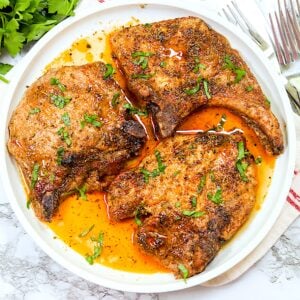 Delectable and super easy 4-Ingredient Oven-Baked Pork Chops on a white platter