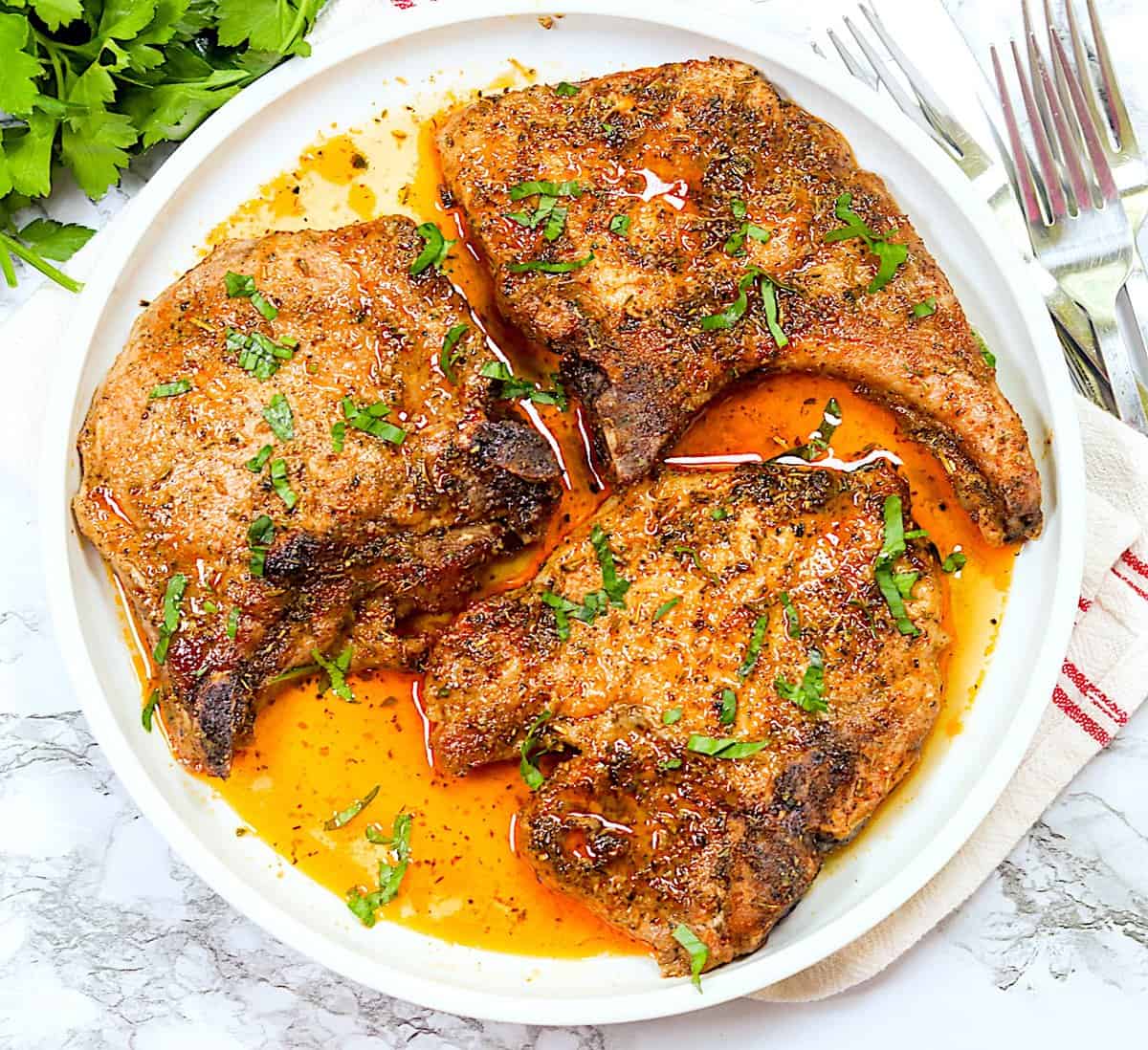 Delectable and super easy 4-Ingredient Oven-Baked Pork Chops on a white platter