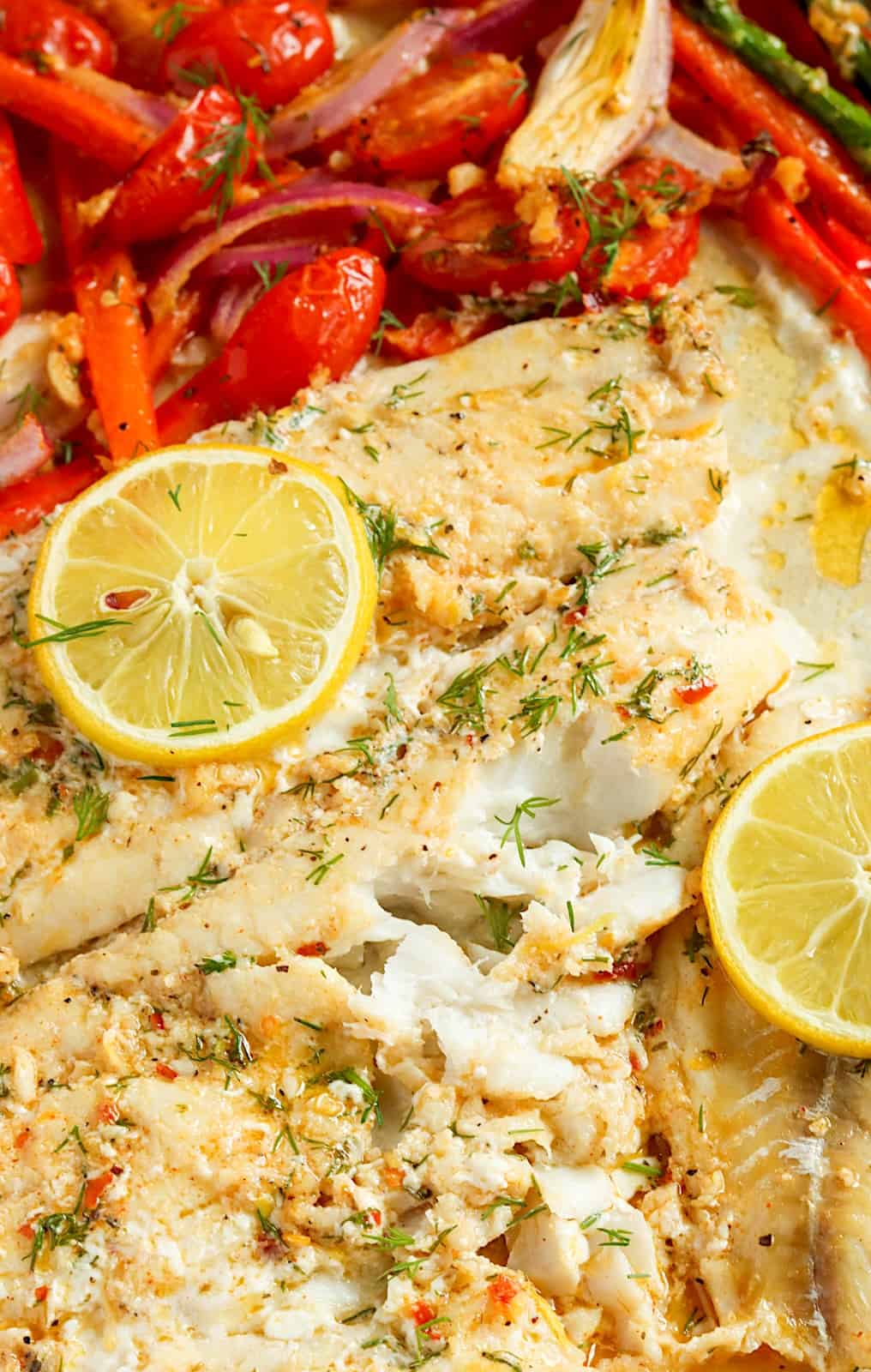 Flaky and tender Baked Rockfish with cherry tomatoes and lemon slices