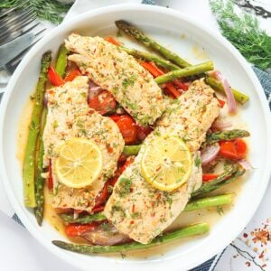 Delicious and healthy Baked Rockfish fresh from the oven with succulent vegetables on a white plate