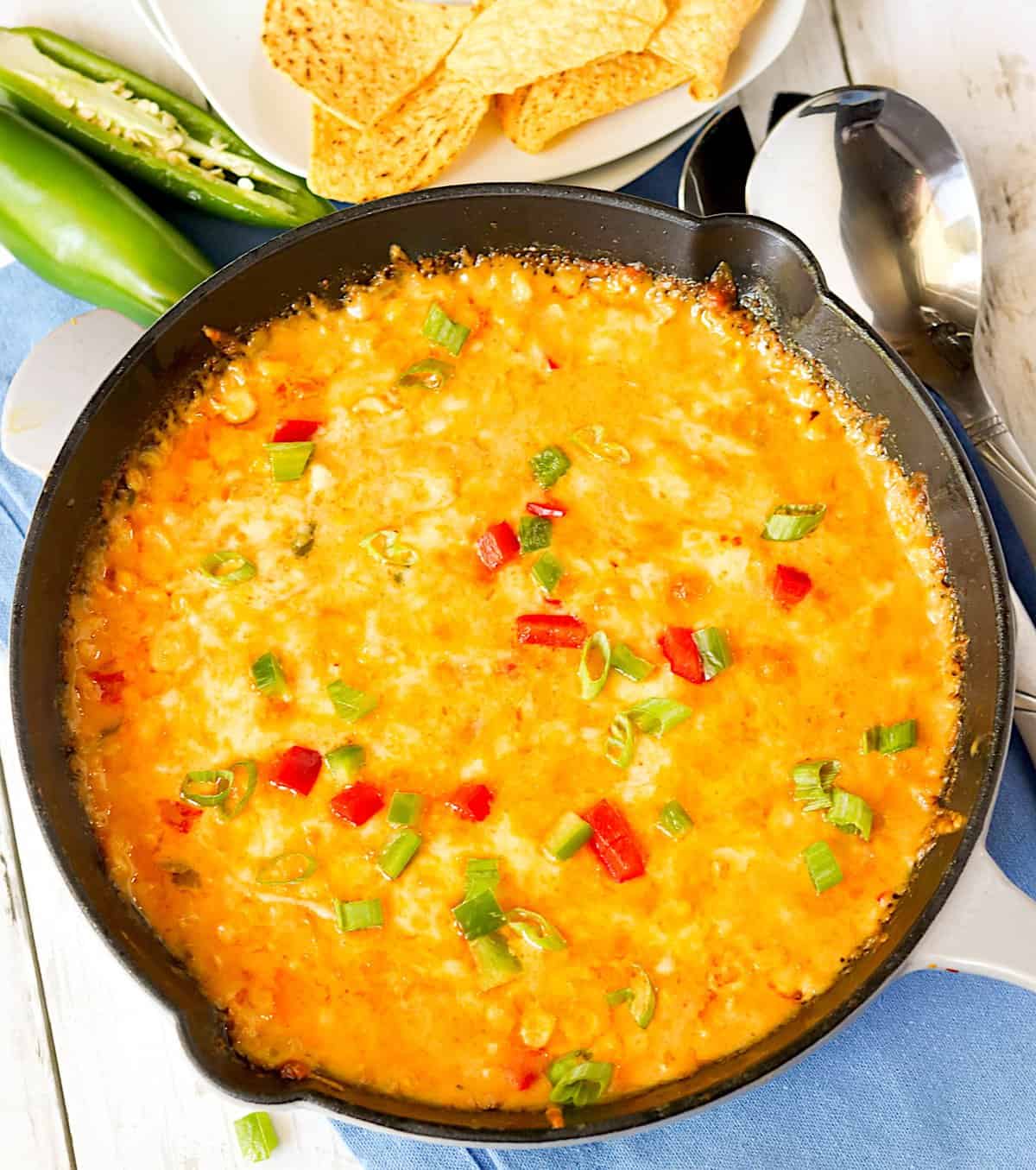 Taking fresh skillet with hot corn dip from the oven 