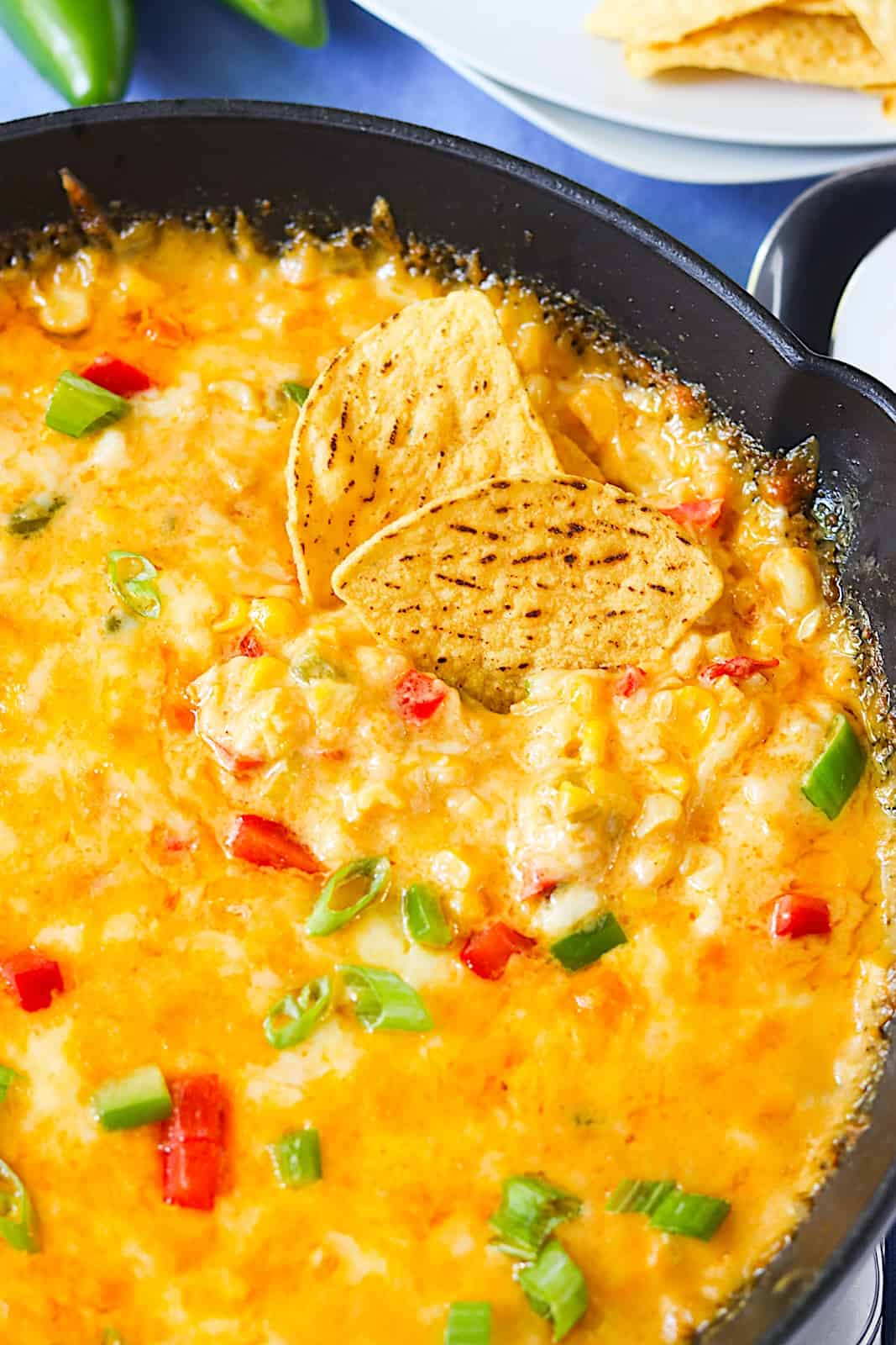 Digging into hot corn dip with homemade tortilla chips